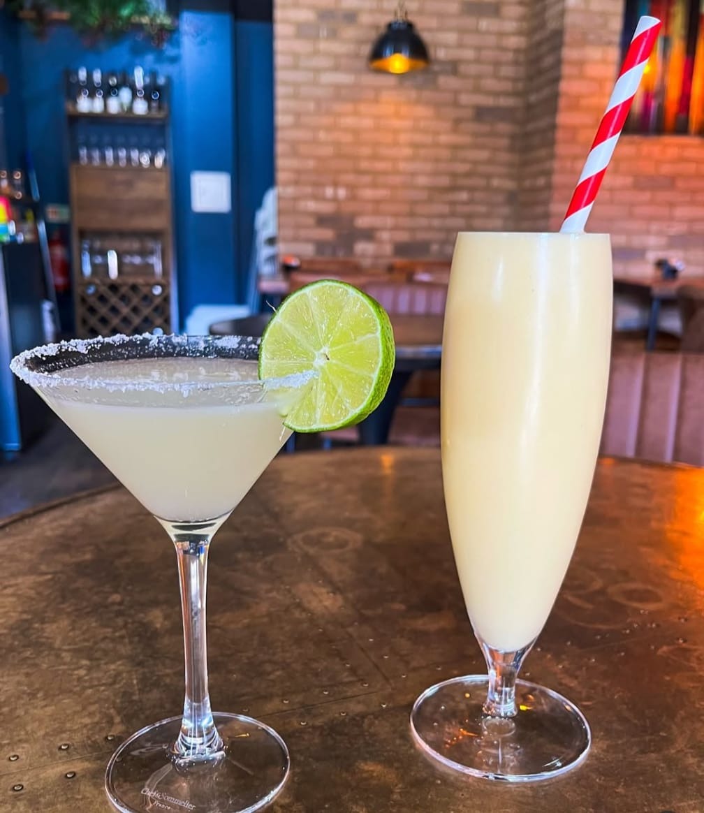 A frozen margarita and a piña colada on the bar at Coffee Squared